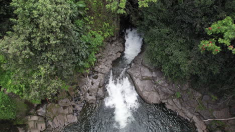 Aerial-push-in-towards-Hawaiian-pool-fed-by-waterfall