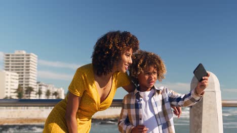mother and son taking selfie at beach