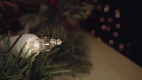 close up of christmas light turning on, illuminating the space