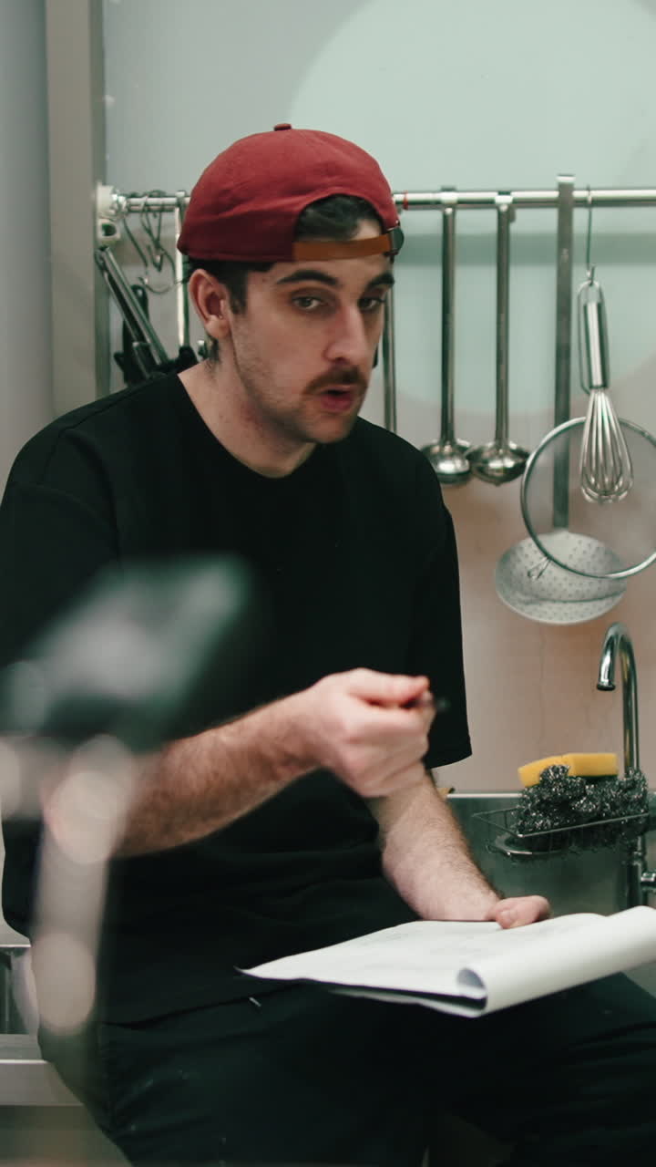 Chef in Kitchen with Notepad