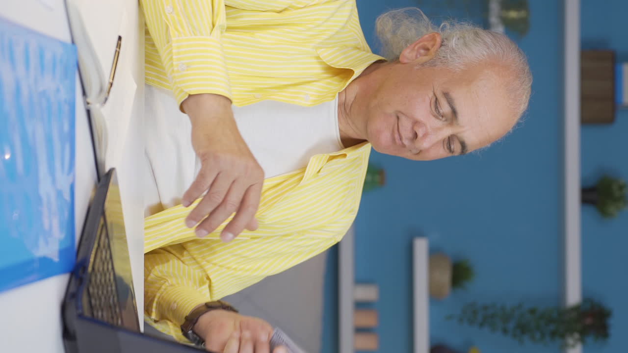 Vertical video of Home office worker old man is rich.
