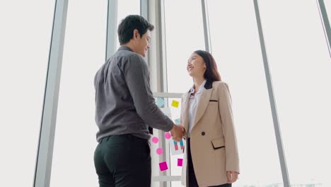 Business-people-handshake-in-corporate-office