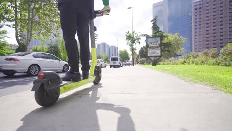 businessman feet using electric scooter.