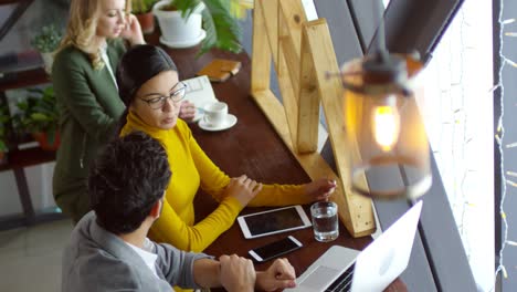 two young colleagues talking in a modern stylish cafe