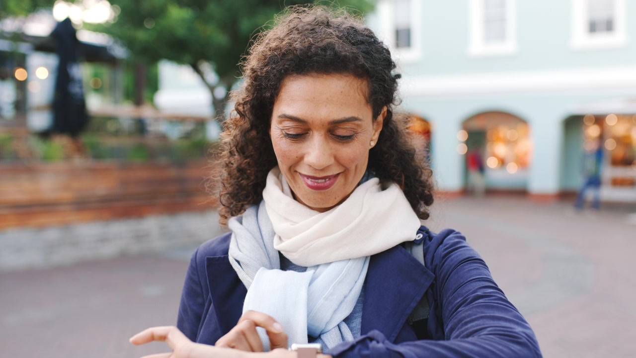 Woman Checking Her Smartwatch While Standing Outdoors