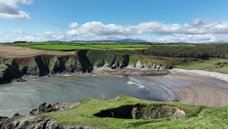 aerial coast of ireland blow hole at kilmurrin cove on the copper coast waterford on a perfect summer day