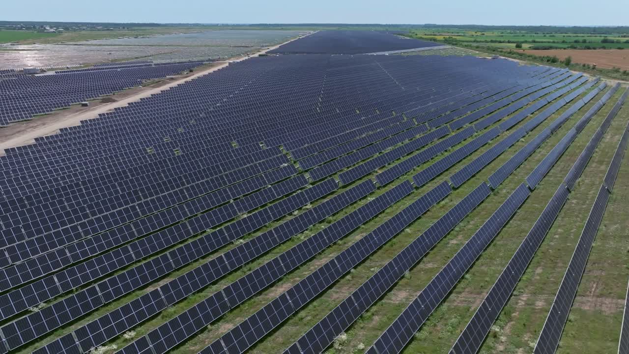 Large solar farm with panels in rows on a sunny day, eco-friendly energy