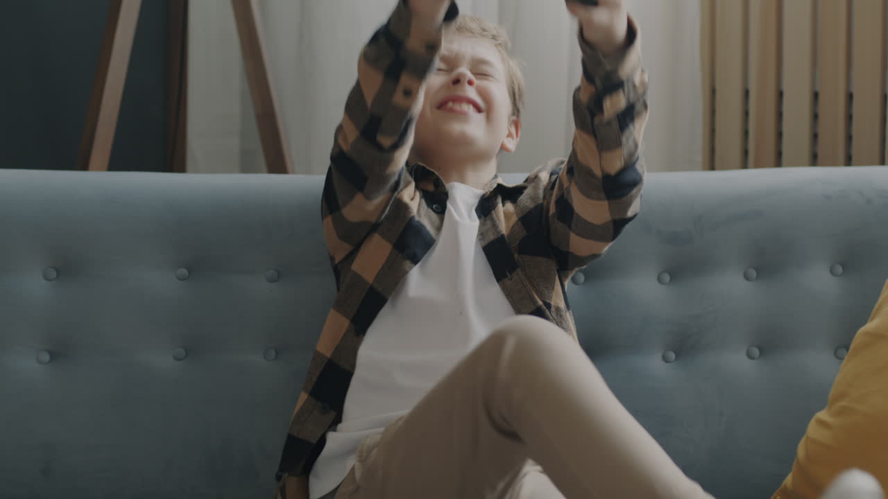 Boy Playing Video Games on a Couch