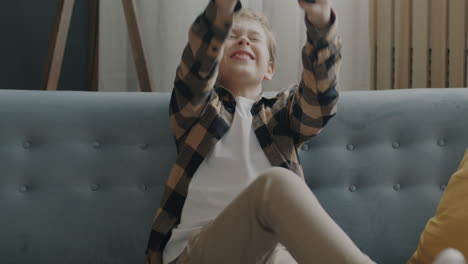 boy playing video games on a couch