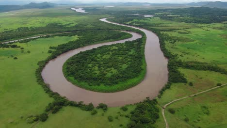 aerial drone shot view river meandering like a snake, tropical rain forest, natural wilderness