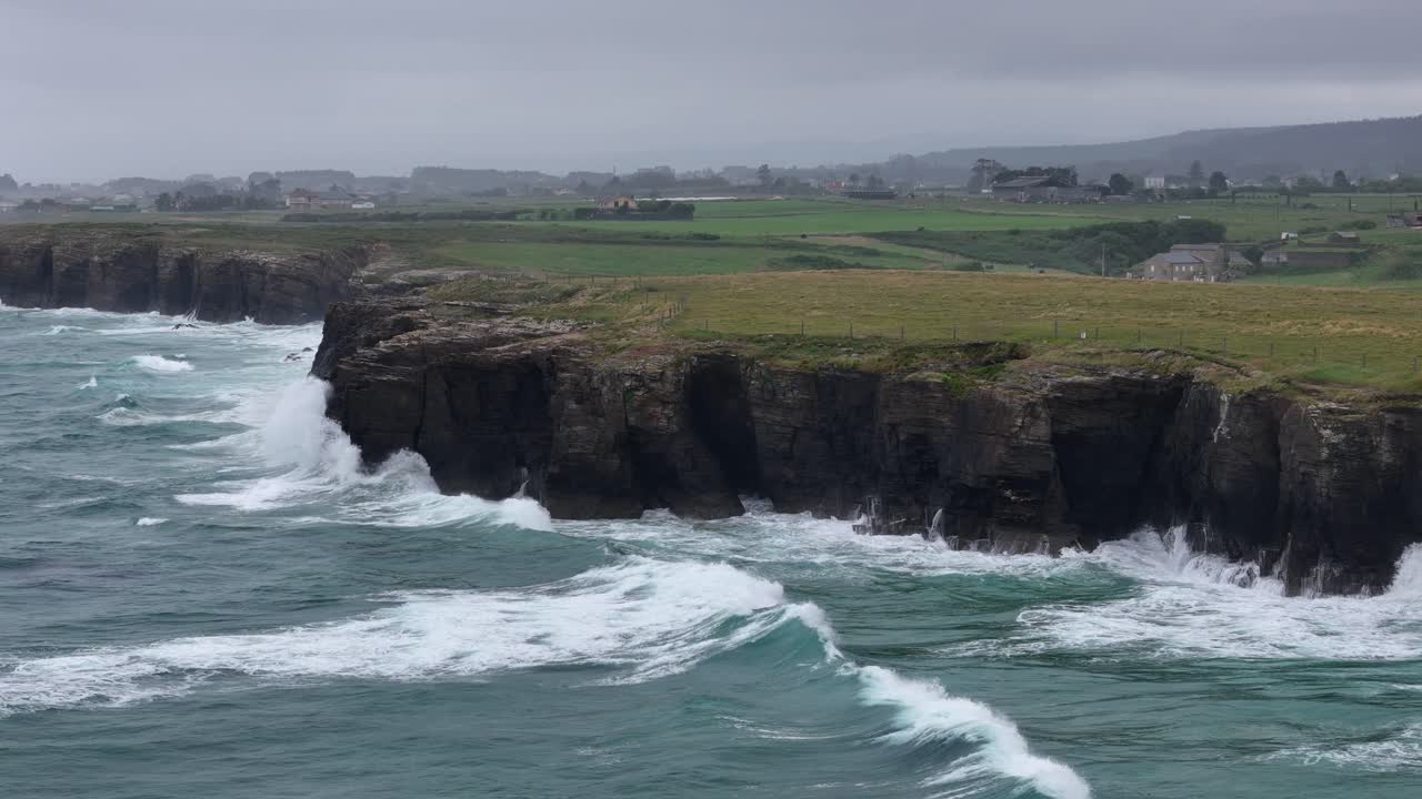 Pull back drone aerial reverse reveal coastal cliffs As Catedrais , Cathedrals beach Northern Spain drone,aerial