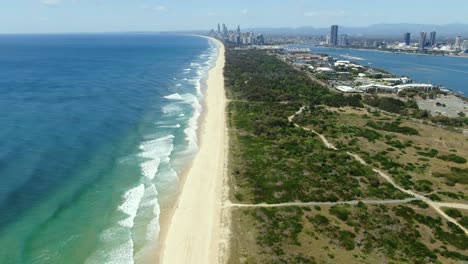 distant view of waves slowly rolling to the perfect beaches of surfers paradise, gold coast, queensland , australia