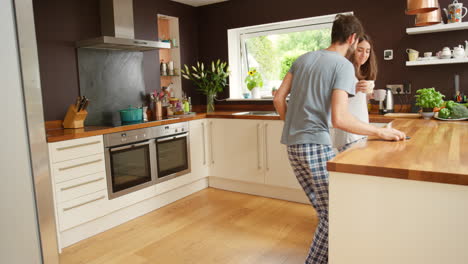 couple dancing in kitchen in pajamas