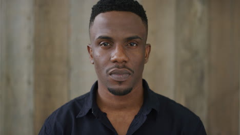 portrait of young african american man looking serious at camera calm independent black male real people series