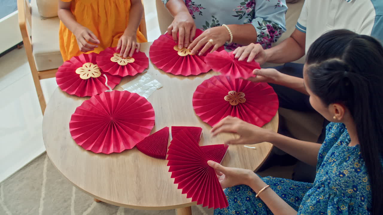 Group of People Crafting Paper Decorations for Tet Celebration