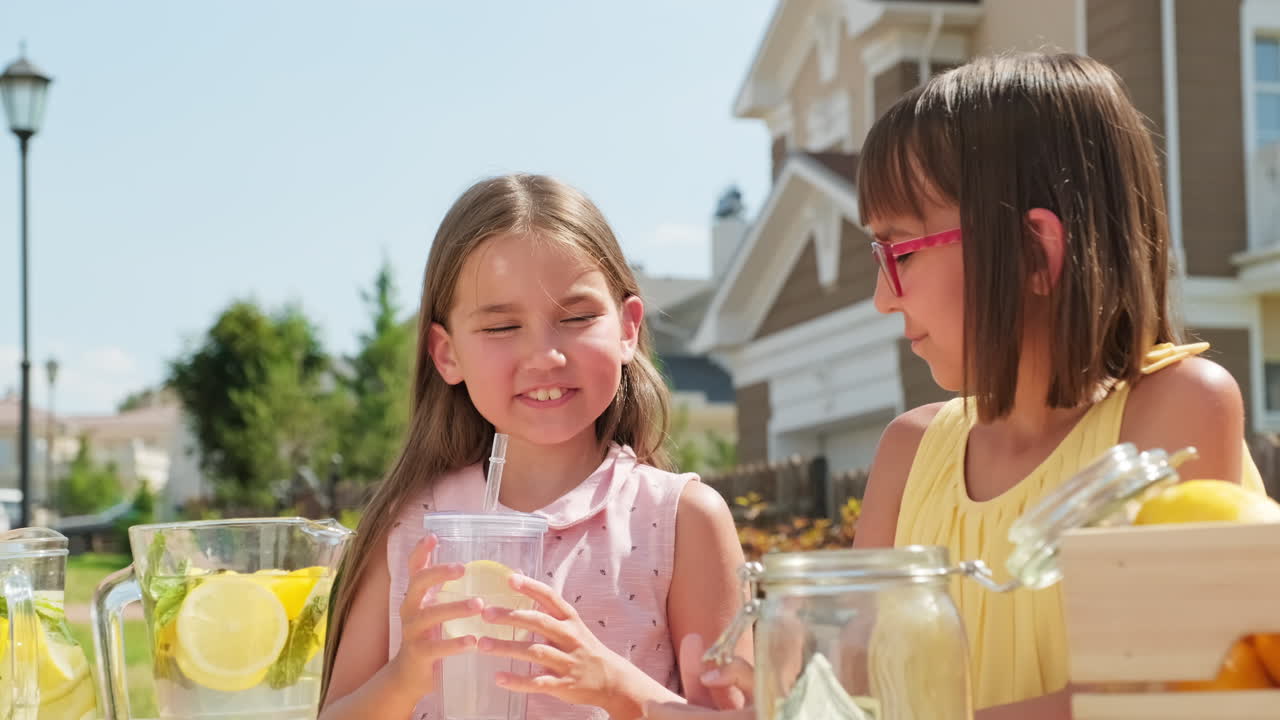 Little Girls Enjoying Homemade Lemonade Outdoors
