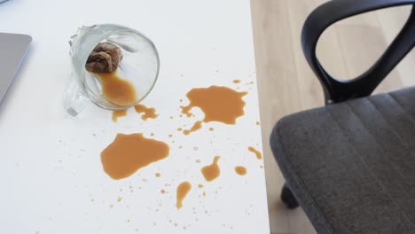 a spilled cup of coffee on a desk