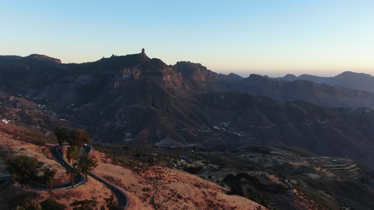 Panoramic aerial view of the roads of Tejeda and the majestic Roque Nublo at sunset on the island of Gran Canaria