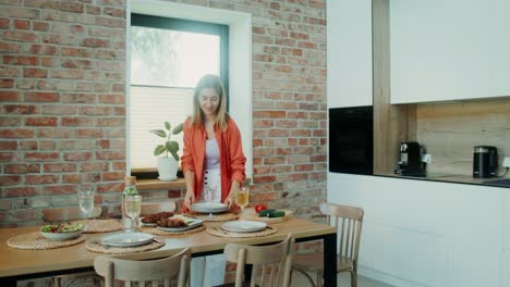 woman setting a table in a modern kitchen