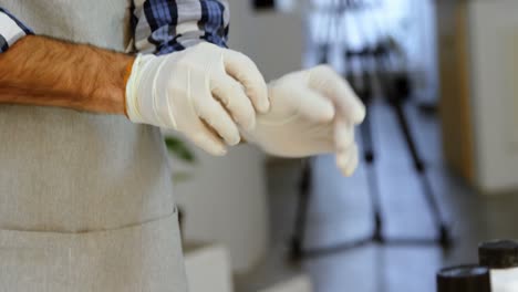 male photographer wearing hand gloves in photo studio 4k