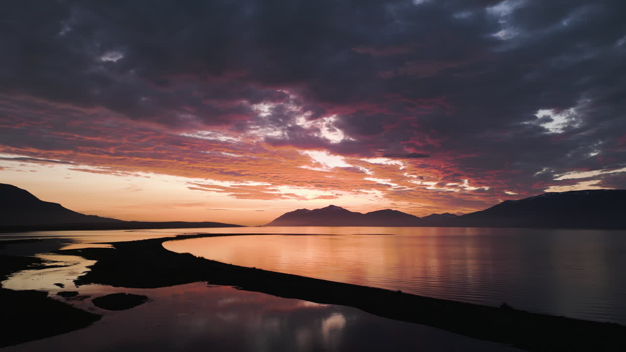 Iceland sunset with colorful sky over calm waters in golden hour magic