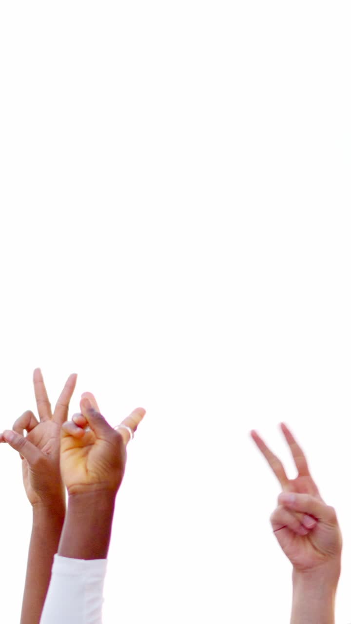 Hands of multi-ethnic people gesturing victory