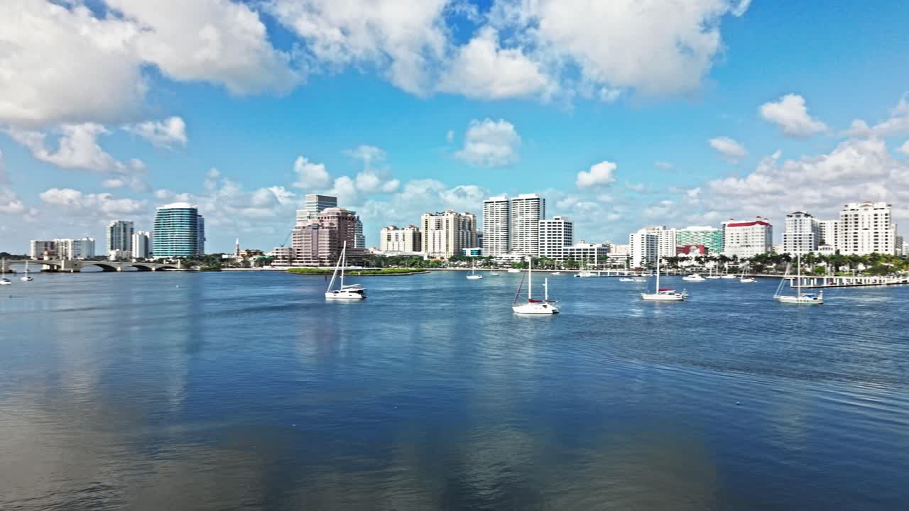 Pan drone shot of marina with Royal Park Bridge, One Flagler and Phillips Point building in West Palm Beach, Florida, USA
