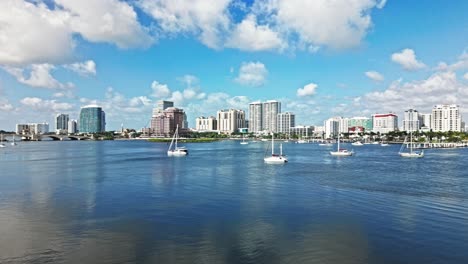 pan drone shot of marina with royal park bridge, one flagler and phillips point building in west palm beach, florida, usa