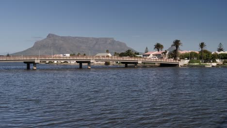 vehicle traffic on low bridge to woodbridge island in cape town, rsa