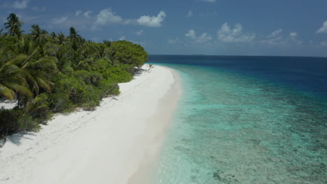 aerial of white beaches and crystal clear water in the maldives