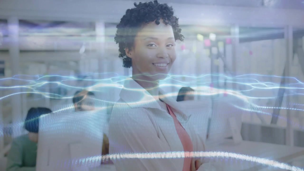 corporate employee reacting to light waves in office, turning to face camera smiling engaging team