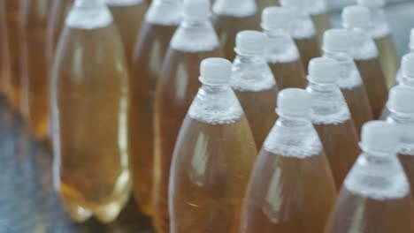 conveyor belt with bottles for juice or water at a modern beverage plant. modern production of sweet soda water