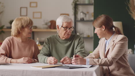 elderly couple and financial advisor posing for camera with smile