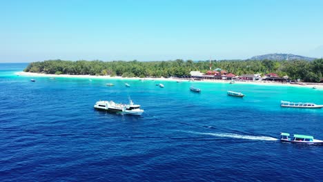 Island-In-Vanuatu---Boats-Swiftly-Sailing-Over-The-Deep-Blue-Ocean-Water-Near-The-Lush-Island-On-A-Sunny-Day---A-Perfect-Tourist-Destination---Wide-Shot