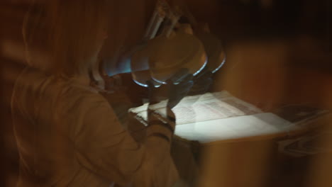 archivist examining a medieval manuscript