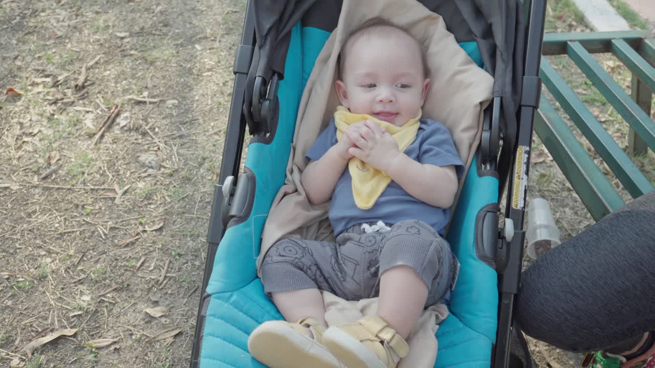 Laughing little baby in stroller