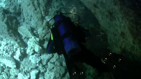 a scuba diver explores underwater caves in florida 1