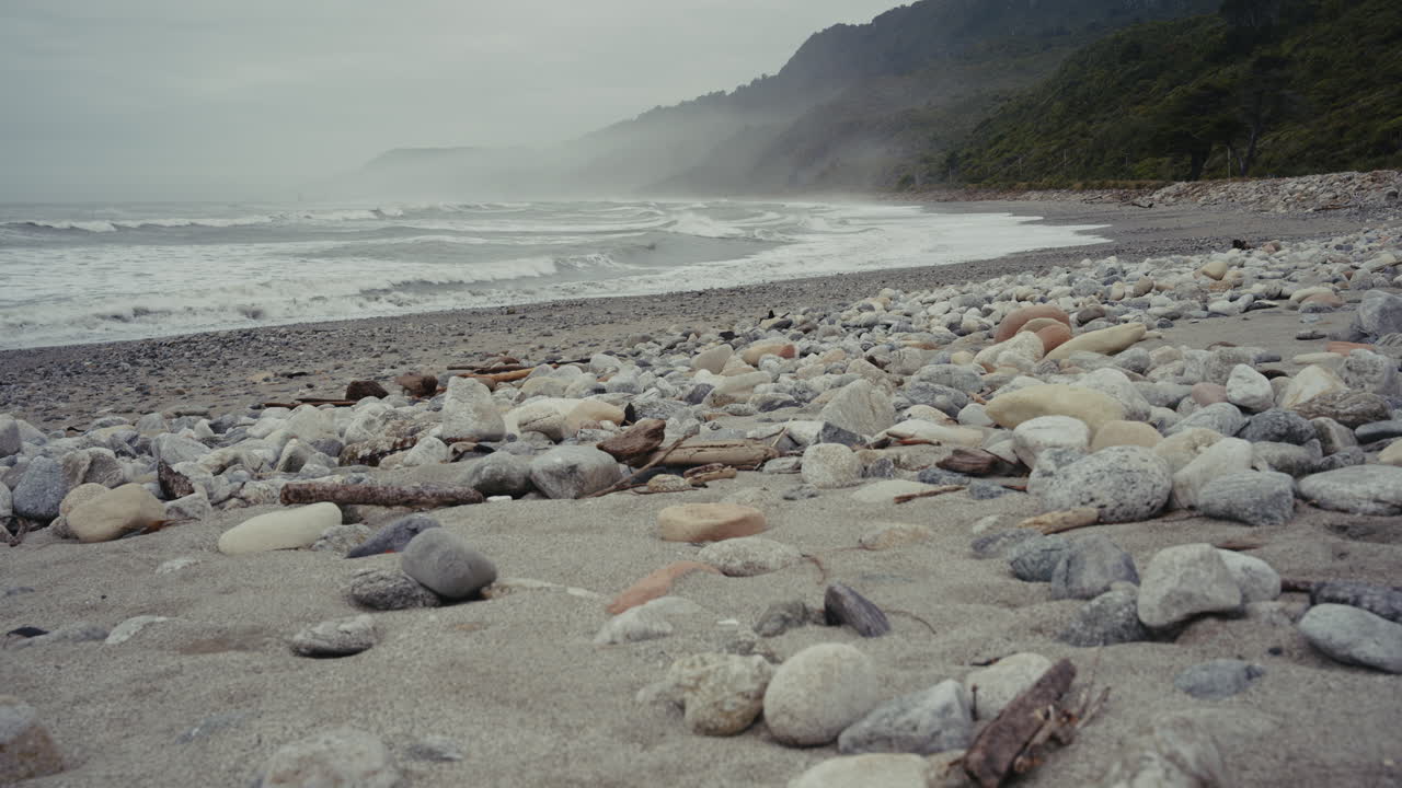 Misty Beach Scene with Rocks and Waves