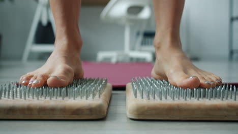 feet on a nail mat for reflexology
