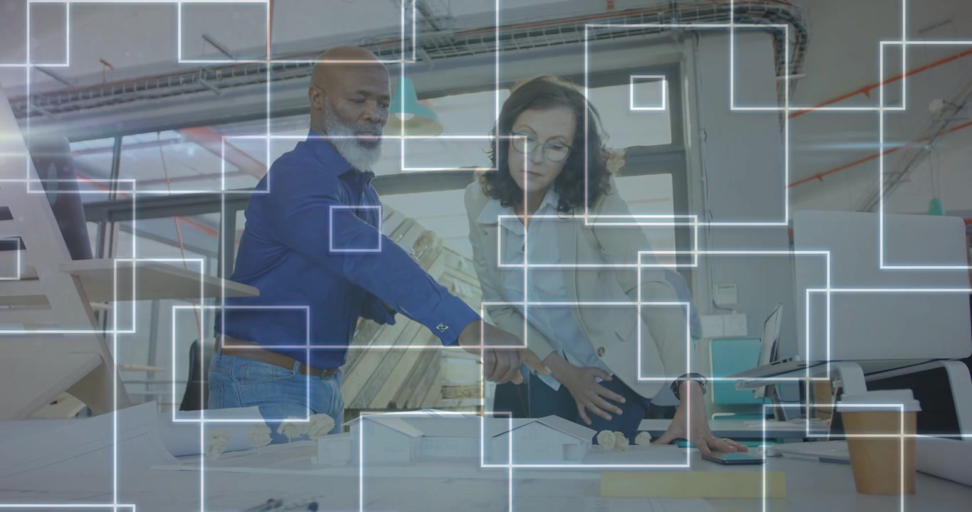 Man reaching plans, woman placing models on table, overlay moving across view, team refining design