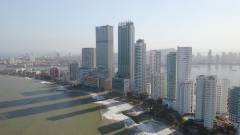 drone flying toward skyscrapers on cartagena's coast