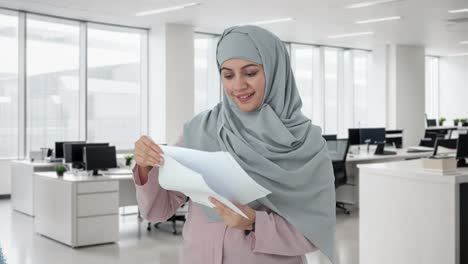 happy muslim businesswoman reading reports