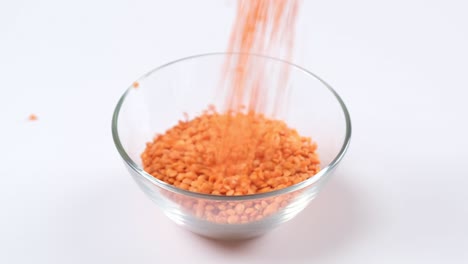 red lentils in a glass bowl on white background. healthy organic food diet concept. fresh natural food ingredient