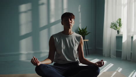 young person meditating in a room