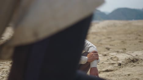 man sitting in dry land