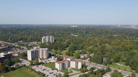 Aerial-shot-flying-over-the-outskirts-of-a-London-neighborhood-near-a-forest-on-a-hazy-day