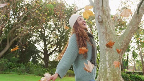 Video-of-biracial-woman-warmly-dressed-spending-time-in-the-garden