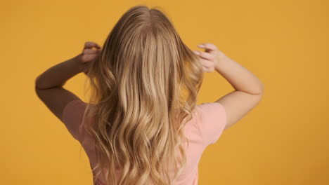 caucasian woman waving hair on camera.