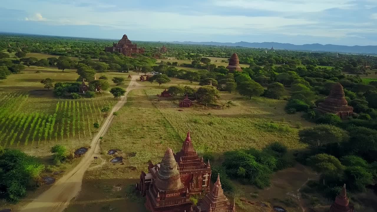 A breathtaking aerial view of a sunset illuminating the temple pagodas in Bagan, Myanmar. Captures the serene beauty and cultural heritage of this ancient sacred site.