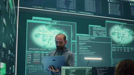 governmental hacker examines info on a big screen in agency office